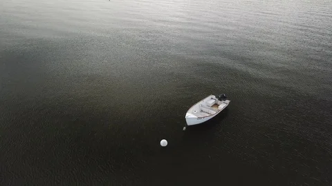 Aerial View 4K - Moored Boat on Calm Seas - Rotating Stock Footage 118002553