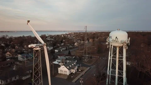 Aerial View 4K - Ocean Gate Two Broken Wind Turbines and Water Tower - Backwards Stock Footage 125839635