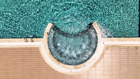 Aerial View 4K: Pinnacle of Poolside - Elite Complexs Crown Jewel Unveiled Stock Footage 293490899