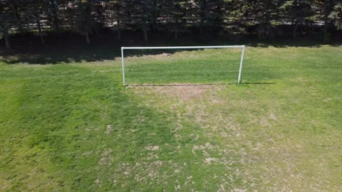 Aerial View 4K pull back over an empty soccer field, suburbs Stock Footage 154459737