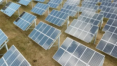 Aerial View 4K - Solar Panel Farm - Low Altitude with Cloud Reflections Stock Footage 124446822