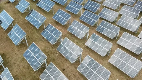 Aerial View 4K - Solar Panel Farm - Backwards Angle with Cloud Reflections Stock Footage 124448249