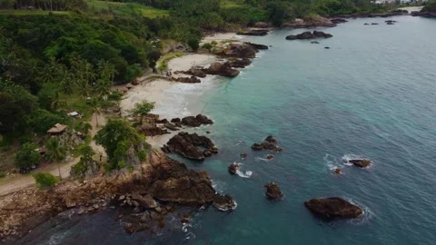 Aerial view 4K of steep cliffs on Bali beach Stock Footage 289759893