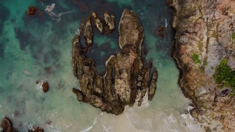 Aerial view 4K of steep cliffs on Bali beach Stock Footage 289759906