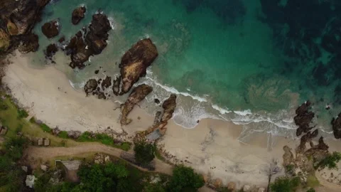 Aerial view 4K of steep cliffs on Bali beach Stock Footage 289759938