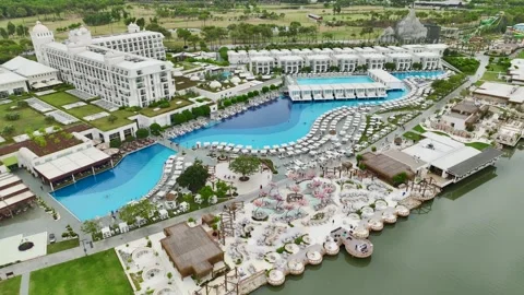 Aerial View 4K: Symphony in Blue - Elite Complexs Harmonious Pool Design Stock Footage 293486749