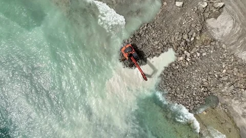 Aerial View 4K: Titans at Work - Transforming the Stony Shoreline Stock Footage 293461478