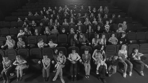 Aerial view, 4K. Video frames at the cinema with funny kids, who watch cartoon Stock Footage 75956516