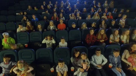 Aerial view, 4K. Video frames at the cinema with funny kids, who watch cartoon 스톡 동영상 76005939