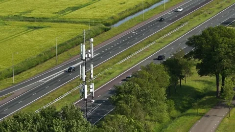 Aerial view of 5g cell tower and traffic on a highway Stock Footage 337778511