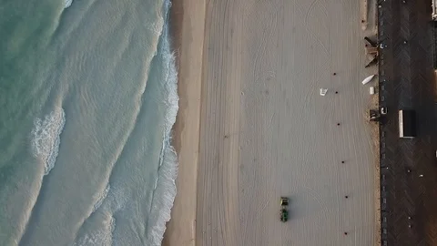 Aerial View 60fps - Beach Sweeper in Seaside Heights - Stationary Lookdown Stock Footage 114450435