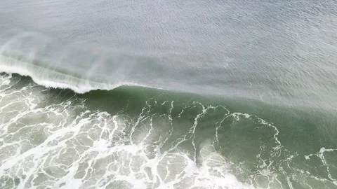 Aerial View 60fps - Breaking Ocean Waves with Spray - Stationary Lookdown Stock Footage 124031631