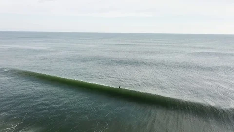 Aerial View 60fps - Winter Surfer Passes Over Top of Wave Stock Footage 124031489