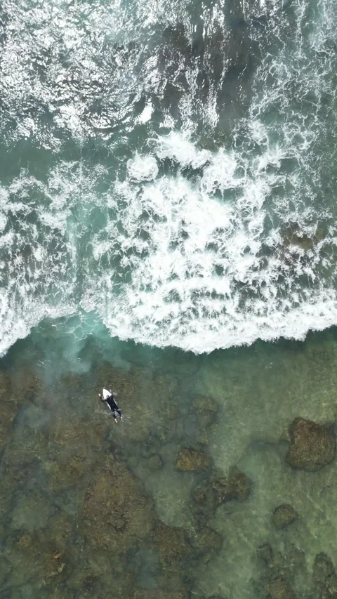 Aerial view 90 degrees surfer in the sea Stock Footage 288083510