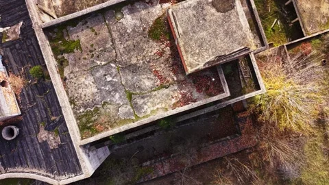 Aerial view of an abandoned building complex in overgrown nature Stock Footage 327144487