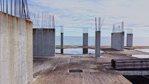 Aerial view of abandoned construction site by the ocean Stock Footage 325086298