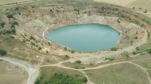 Aerial view of abandoned copper mine filled with water, surrounded by fields Stock Footage 134067484