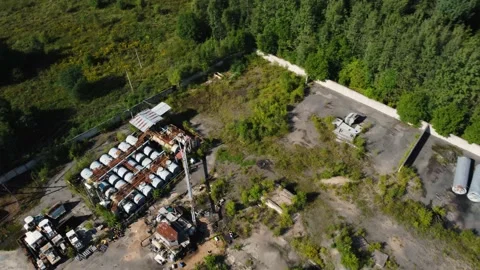 Aerial view to abandoned industrial base with rusty oil storage tanks. Stock Footage 163376592