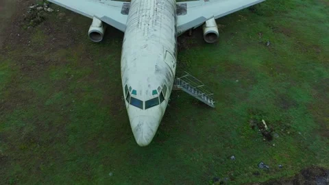 Aerial view of an abandoned old plane on a grassy field, Uluwatu, Indonesia. Stock Footage 345228818
