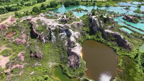 Aerial view of abandoned quarry, now lush with greenery 動画素材 344817110