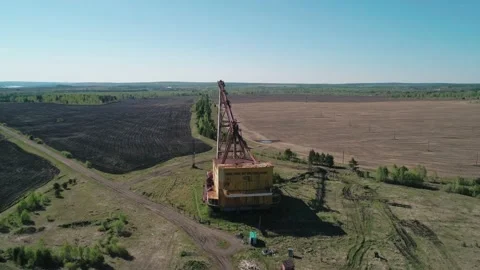 Aerial view of an abandoned rusty walking excavator somewhere in the rural area Stock Footage 223360202