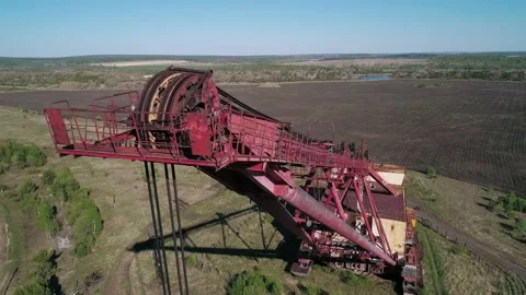 Aerial view of an abandoned rusty walking excavator somewhere in the rural area Stock Footage 223362307
