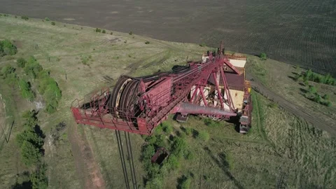 Aerial view of an abandoned rusty walking excavator somewhere in the rural area Stock Footage 223362796