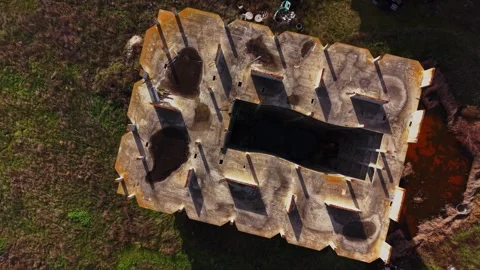 Aerial view of an abandoned structure with shadows and overgrowth Stock Footage 325085228