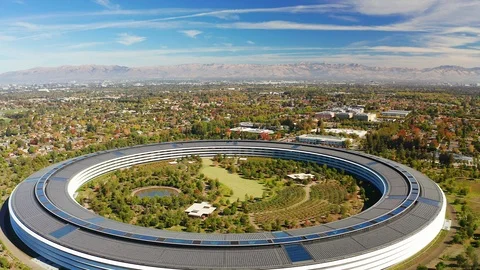 Aerial view above Apple Park spaceship headquarters in Cupertino California Stock Footage