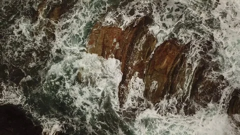 Aerial view from above bottom up. Waves moving on the rocks. Background Texture Stock Footage 100329610