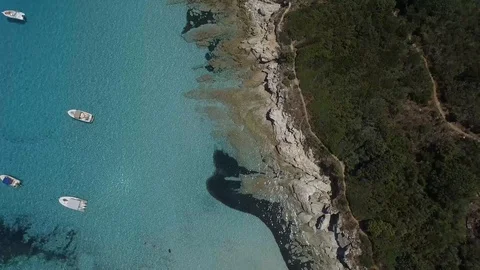 Aerial view above a cliff surrounded by coastal rocks on a beautiful bay,Corsica Stock-Footage 85466909