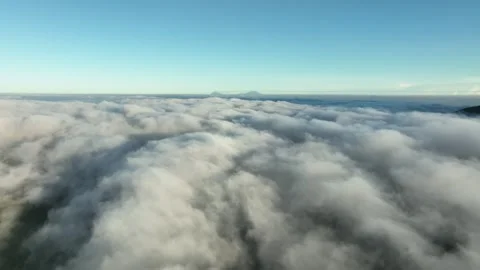 Aerial View Above Clouds and Mountains at Sunrise 스톡 동영상 244723890