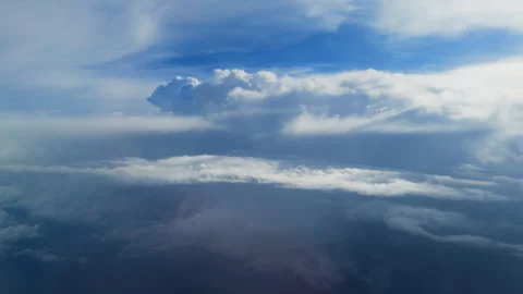 Aerial View Above Clouds with Dramatic Cumulonimbus Formation in Blue Sky. Stock Footage 338360575