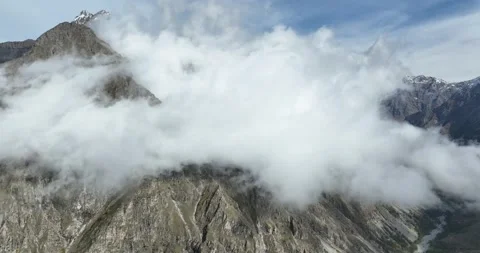 Aerial view above the clouds, at high altitude, in the mountains of the Alps Stock Footage 314008001