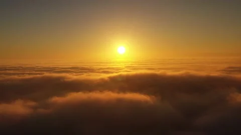 Aerial view above a clouds in a light of rising sun Stock Footage 143349565
