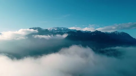 Aerial view above the clouds with mountains in the background Stock Footage 234639952