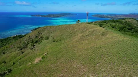 Aerial view above coral reef surrounding tropical Island Stock Footage 318642553