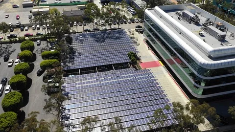 Aerial view above high tech business car park solar panel installation. Stock Footage 117935287
