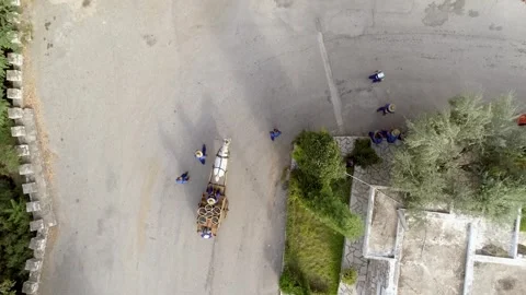 Aerial view above of horse pulling wagon on road. Video stock 345226021