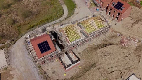 Aerial view above new build houses with exposed roof beams and solar panels Video stock 332673889