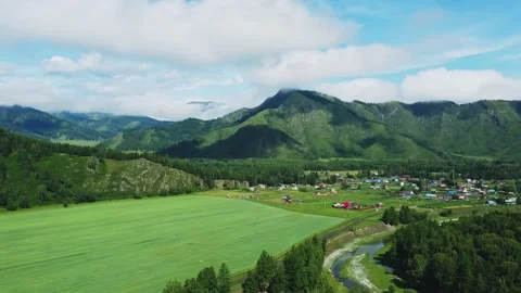 Aerial view from above over a mountain valley and an alpine village. Video stock 303360461