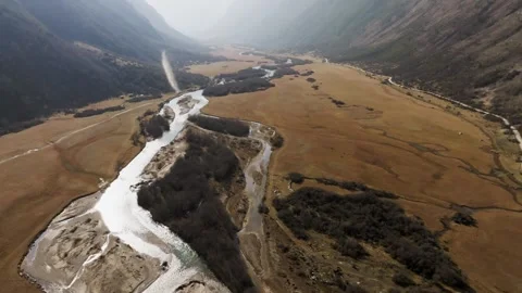 An aerial view from above of a small river stream flowing in a mountain gorge on Stock Footage 340274768