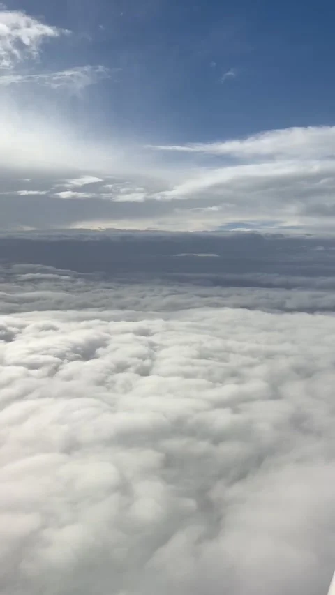 Aerial View Above a Soft Blanket of Clouds from an Airplane Stock Footage 339378634
