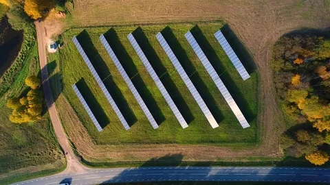 Aerial view of above solar panel rows during strong sunlight, Estonia. Stock Footage 101569485