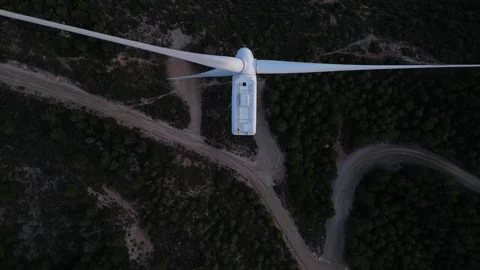 Aerial view from above of spinning wind turbine blades generating green energy Stock Footage 327127726
