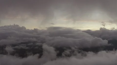 Aerial view above thick clouds moving forwards swiftly above rainforest with 스톡 동영상 284247852