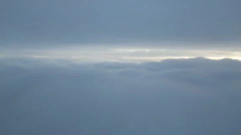 Aerial View Above Thick Clouds with Sun Peeking Through Horizon 스톡 동영상 332713627