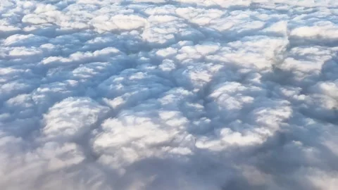 Aerial view above thick white clouds from an airplane, showing soft cloud Stock Footage 339090656