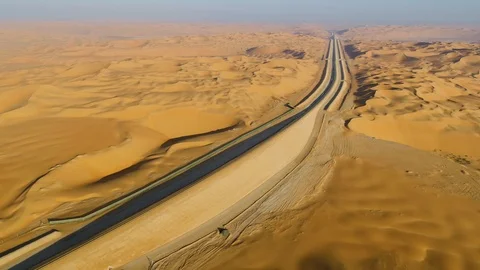 Aerial view above of train rail crossing vast desert, U.A.E. Stock Footage 103052334