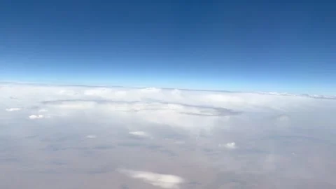 Aerial view above white cloud layer and clear blue sky in 4K Stock Footage 343376183